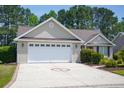 Attached two-car garage with brick-lined driveway and low-maintenance landscaping at 1044 Vestry Dr., Murrells Inlet, SC 29576
