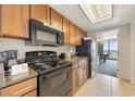 Well-equipped kitchen with black appliances, granite countertops, and ocean views at 1105 S Ocean Blvd. # 928, Myrtle Beach, SC 29577
