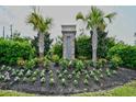 The Sanctuary community sign featuring lush landscaping, flowers, and mature palm trees at 1141 Prescott Circle, Myrtle Beach, SC 29577