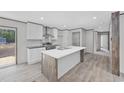 Bright kitchen featuring a center island, stainless steel appliances, and a door to the back deck at 1300 Rabbit Ln., Conway, SC 29526