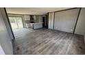 Spacious living room featuring an open floor plan, gray walls and laminate flooring, leading into the kitchen at 1300 Rabbit Ln., Conway, SC 29526
