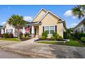 Inviting single-story home with a well-maintained lawn and an inviting front porch at 1404 Riverport Dr., Conway, SC 29526