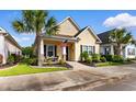 Charming yellow single-story home featuring a well-manicured lawn and inviting entryway at 1404 Riverport Dr., Conway, SC 29526