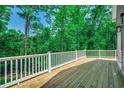 Enjoy the outdoors on this spacious wooden deck with views of lush greenery at 1673 Carriage Ln., Little River, SC 29566