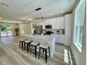 Modern open-concept kitchen featuring stainless steel appliances and a spacious island with bar stool seating at 1673 Carriage Ln., Little River, SC 29566