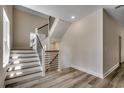 Stylish staircase with modern wood and metal railings, complemented by durable wood flooring at 1673 Carriage Ln., Little River, SC 29566