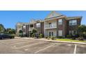 Charming two-story brick condo building featuring balconies and well-maintained landscaping at 2029 Silvercrest Dr. # 22B, Myrtle Beach, SC 29579