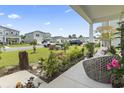 View from the porch highlighting the meticulously landscaped front yard and the neighborhood at 205 Marsh Deer Place, Surfside Beach, SC 29575