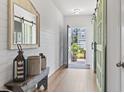 Bright entryway featuring hardwood floors, shiplap accent wall, and stylish barn doors at 205 Marsh Deer Place, Surfside Beach, SC 29575