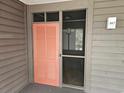 The condo entryway features a stylish peach-colored door and a convenient screen door at 207 N 3Rd Ave. N # 247, North Myrtle Beach, SC 29582
