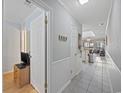 Hallway leading to a bright and inviting living space with tiled floors and crisp white moldings at 210 N Ocean Blvd. # 333, North Myrtle Beach, SC 29582