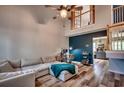 Bright living room with vaulted ceilings, a ceiling fan, wood flooring, a comfortable sectional, and a workspace at 3120 Mercer Dr., Conway, SC 29526