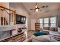 Inviting living room featuring a staircase, vaulted ceilings, wood flooring, comfortable sectional, and a media center at 3120 Mercer Dr., Conway, SC 29526