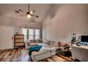 Cozy living room with vaulted ceilings, wood flooring, comfortable sectional sofa, and sun-lit windows at 3120 Mercer Dr., Conway, SC 29526
