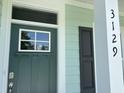 Close-up of the front door with sidelight, house number, and siding at 3129 Tiger Tail Rd., Conway, SC 29526