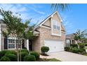 Well-maintained two-story home featuring a brick facade, manicured landscaping, and two-car garage at 3210 Volterra Way # 3210, Myrtle Beach, SC 29579