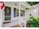 Inviting front porch with decorative door and hanging plants, perfect for relaxing at 4311 Bradford Circle, Myrtle Beach, SC 29588