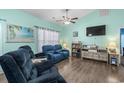 Cozy living room with comfortable seating, a modern entertainment center, and beach-themed wall decor at 4338 Grande Harbour Blvd., Little River, SC 29566