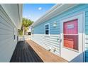 Side view showcasing the wood deck and light blue siding of the charming coastal home at 4338 Grande Harbour Blvd., Little River, SC 29566