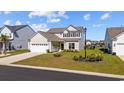 Beautiful single Gathering home featuring a well-maintained lawn, attractive landscaping, and a two-car garage at 4410 Honir Dr., Myrtle Beach, SC 29579