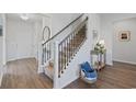 Inviting foyer showcasing hardwood floors, a staircase with decorative iron spindles, and neutral décor at 4410 Honir Dr., Myrtle Beach, SC 29579