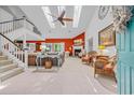 Bright living room with high ceilings, skylights, fireplace, and staircase leading to the open second level at 444 Dornoch Dr., Pawleys Island, SC 29585