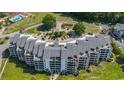 This stunning waterfront condo features expansive balconies and lush landscaping at 4440 Nassau Ct. # 308, Little River, SC 29566