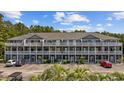 Attractive condo building featuring multi-level balconies, well-manicured landscaping, and convenient parking at 4506 West Harbor Ct. # U-15, Little River, SC 29566