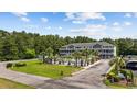 Condo building next to a pool featuring multi-level balconies, well-manicured landscaping, and convenient parking at 4506 West Harbor Ct. # U-15, Little River, SC 29566