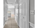 Neutral-toned hallway with closet, leading to a kitchen and living area with natural light at 4705 Wild Iris Dr. # 305, Myrtle Beach, SC 29577