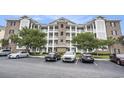 Beautiful condo building with multiple balconies, brick accents, and well-manicured landscaping at 4895 Luster Leaf Circle # 302, Myrtle Beach, SC 29577