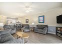 Inviting living room featuring hardwood floors, neutral paint colors, and open access to dining area at 4895 Luster Leaf Circle # 302, Myrtle Beach, SC 29577