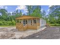 Charming home with a welcoming wooden porch, set in a serene outdoor environment at 491 N Green Sea Rd., Loris, SC 29569