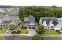 An aerial shot of a stylish home with a gray roof, surrounded by lush greenery and well-maintained landscaping at 5009 Middleton Dr., Myrtle Beach, SC 29579
