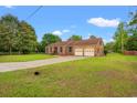 Brick home featuring an extended driveway leading to an attached two-car garage at 5206 Columbia St., Conway, SC 29526