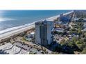 Aerial view of condo building on beach near ocean, offering stunning waterfront access and scenic views at 5523 North Ocean Blvd. # 1903, Myrtle Beach, SC 29577