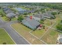 An aerial view of a well-maintained home with a fenced backyard, patio set, and lush surrounding landscape at 600 Tattlesbury Dr., Conway, SC 29526