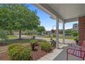 Inviting porch with decorative benches and potted plants, offering a serene outdoor space at 600 Tattlesbury Dr., Conway, SC 29526