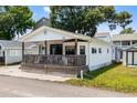 Inviting single-story home featuring a spacious front porch, ideal for relaxation at 6001-5742 S Kings Hwy., Myrtle Beach, SC 29575