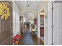 Inviting foyer leading to living areas, showcasing hardwood floors and seamless transition to other rooms at 605 Ginger Lily Way, Little River, SC 29566