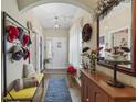 Warm foyer with hardwood floors, arched entryway, decorative accents, and ample natural light at 605 Ginger Lily Way, Little River, SC 29566