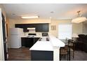 Updated kitchen featuring black cabinets, modern appliances, and stylish lighting at 669 Tupelo Ln. # 18D, Longs, SC 29568