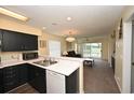 Modern kitchen with sleek black cabinets and a bright, open view into the living area at 669 Tupelo Ln. # 18D, Longs, SC 29568