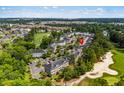Aerial view of complex including golf course and lake; red icon indicates unit at 682 Riverwalk Dr. # 102, Myrtle Beach, SC 29579