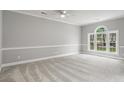 Bedroom with neutral carpet, arched window, and white trim at 682 Riverwalk Dr. # 102, Myrtle Beach, SC 29579