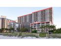 Oceanfront resort featuring balconies and partial ocean views with a dune in the foreground at 7200 N Ocean Blvd. # 360, Myrtle Beach, SC 29572