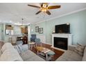 Cozy living room showcasing a fireplace, comfortable seating, and a seamless connection to the kitchen at 750 Howard Ave. # C, Myrtle Beach, SC 29577