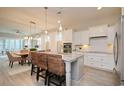 Open-concept kitchen with granite countertops and stainless steel appliances overlooking dining area at 812 Maltby Alley, Myrtle Beach, SC 29588