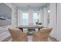 Well-lit office with large windows and elegant wicker chairs for a comfortable workspace at 812 Maltby Alley, Myrtle Beach, SC 29588