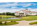 Picturesque golf course view with a clubhouse overlooking the fairway and a serene water feature at 8323 Cape Dutch Loop, Myrtle Beach, SC 29572